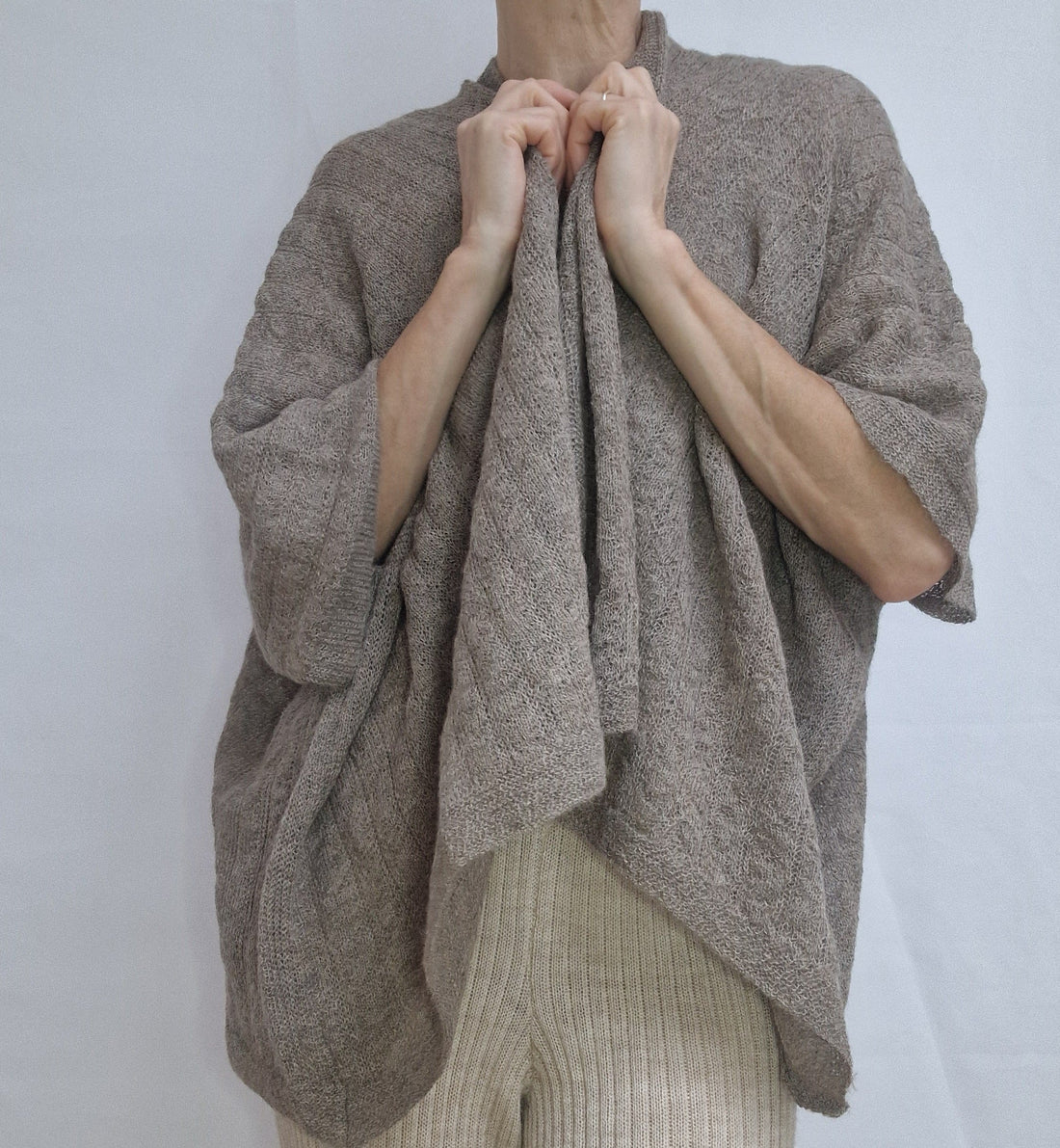 woman wearing an alpaca cape