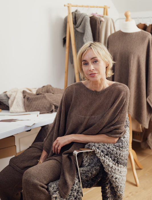 woman wearing alpaca sitting in a studio