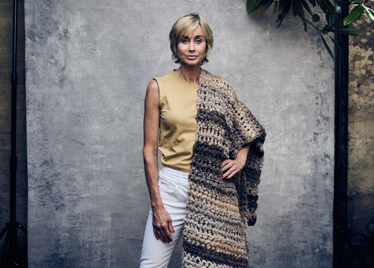 woman wearing alpaca blanket